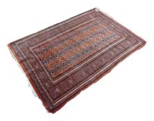 PAKISTAN BOKHARA LARGE RUG, with three rows of fifteen primary guls on a brick red field, broad