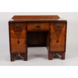 ART DECO FIGURED WALNUT KNEEHOLE DRESSING TABLE, lacking mirrors, the oblong top with short back,
