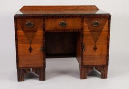 ART DECO FIGURED WALNUT KNEEHOLE DRESSING TABLE, lacking mirrors, the oblong top with short back,