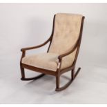 EDWARDIAN MAHOGANY UPHOLSTERED ROCKING CHAIR, the buttoned back flanked by leaf capped downswept