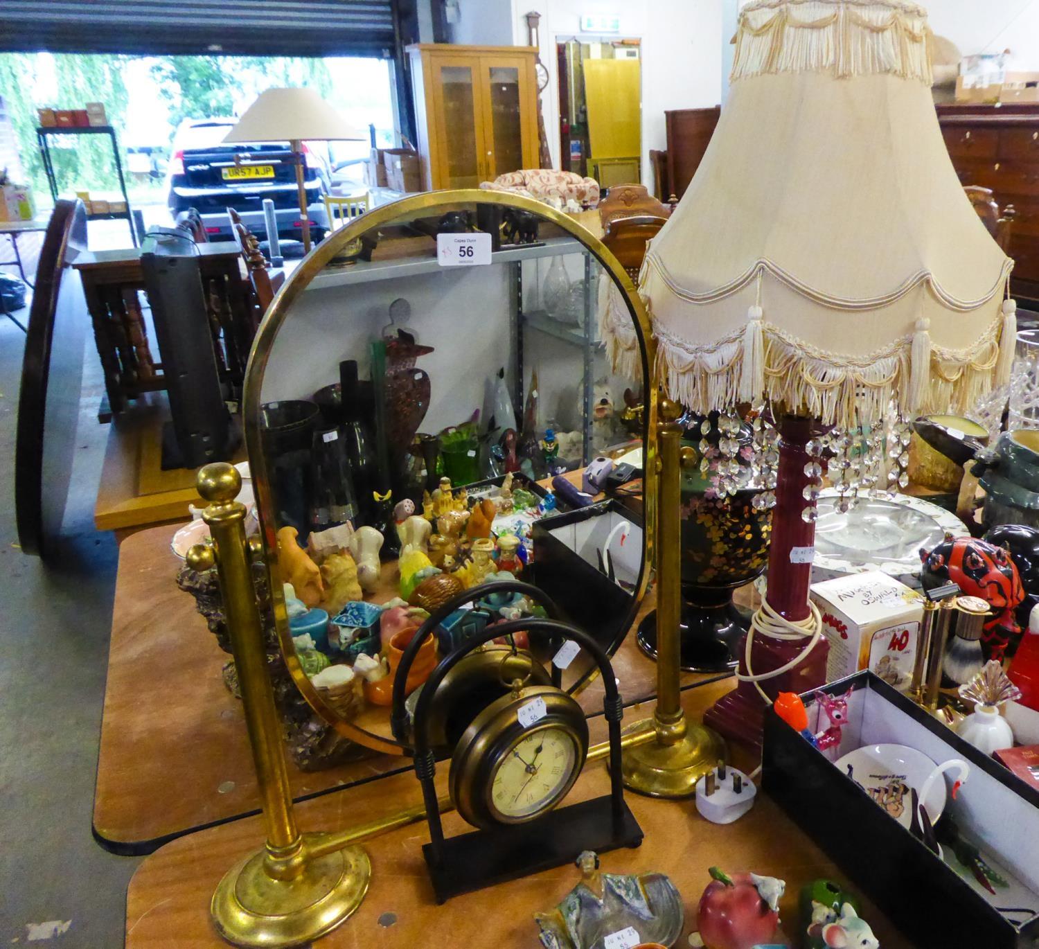 A SMALL BRASS CHEVAL MIRROR, A POTTERY TABLE LAMP AND SHADE AND A SMALL DECORATIVE CLOCK