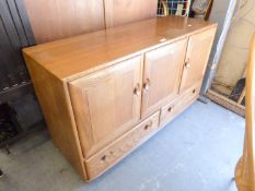AN ERCOL ELM WINDSOR SIDEBOARD, WITH THREE CUPBOARDS ABOVE TWO LONG DRAWERS, RAISED ON CASTORS, (
