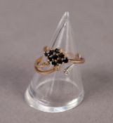 9ct GOLD RING, the three strand top set with three tiny white stones (fourth strand missing) and a