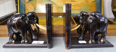 A PAIR OF EBONY ELEPHANT BOOKENDS