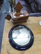 AN OAK MURAL COLLECTION BOX AND A SMALL CIRCULAR FRAMED WALL MIRROR (2)