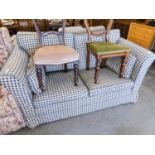 PAIR OF TWO SEATER SETTEES COVERED IN PATTERNED MAROON FABRIC WITH CHECK FABRIC LOOSE COVERS AND THE