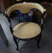 AN EDWARDIAN DARK MAHOGANY TUB SHAPED DRAWING ROOM ARMCHAIR