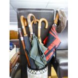 A WALKING STICK WITH SILVER POMMEL AND FIVE UMBRELLAS  (6)