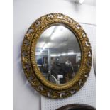 AN OVAL ORNATE GILT FRAMED WALL MIRROR AND A VINTAGE BAGATELLE GAME (2)