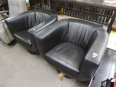 A PAIR OF BLACK LEATHER REVOLVING TUB CHAIRS, ON CIRCULAR CHROME BASES
