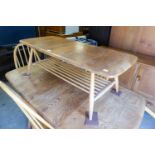 AN ERCOL ELM COFFEE TABLE, WITH MAZAGINE RACK UNDERTIER (94cm x 46cm x 36cm)