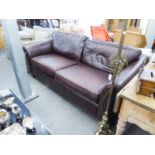 A LARGE DARK BROWN HIDE FOUR CUSHION SETTEE, 7' WIDE