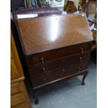 A MAHOGANY BUREAU WITH SLOPING FALL-FRONT, THREE LONG DRAWERS BELOW, ON CABRIOLE LEGS