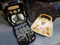 A CANVAS RUCKSACK FITTED PICNIC SET WITH BOTTLE HOLDER, AN EXPANDABLE HOLDALL ON WHEELS AND A