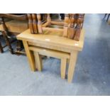 A LIGHT OAK OBLONG COFFEE TABLE, ON HEAVY SQUARE TAPERING LEGS, ANOTHER SMALLER AND A LIGHT OAK