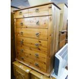 A PINE CHEST OF TWO SHORT AND FIVE LONG DRAWERS WITH BRASS DROP/RING HANDLES AND A SIMILAR BEDSIDE