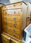 A PINE CHEST OF TWO SHORT AND FIVE LONG DRAWERS WITH BRASS DROP/RING HANDLES AND A SIMILAR BEDSIDE