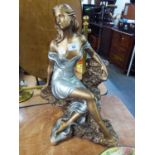 A 'MEMORIES' AUSTIN SCULPTURE FIGURE OF A SEATED WOMAN, BRONZED AND COLOURED AND WEARING A SILVER