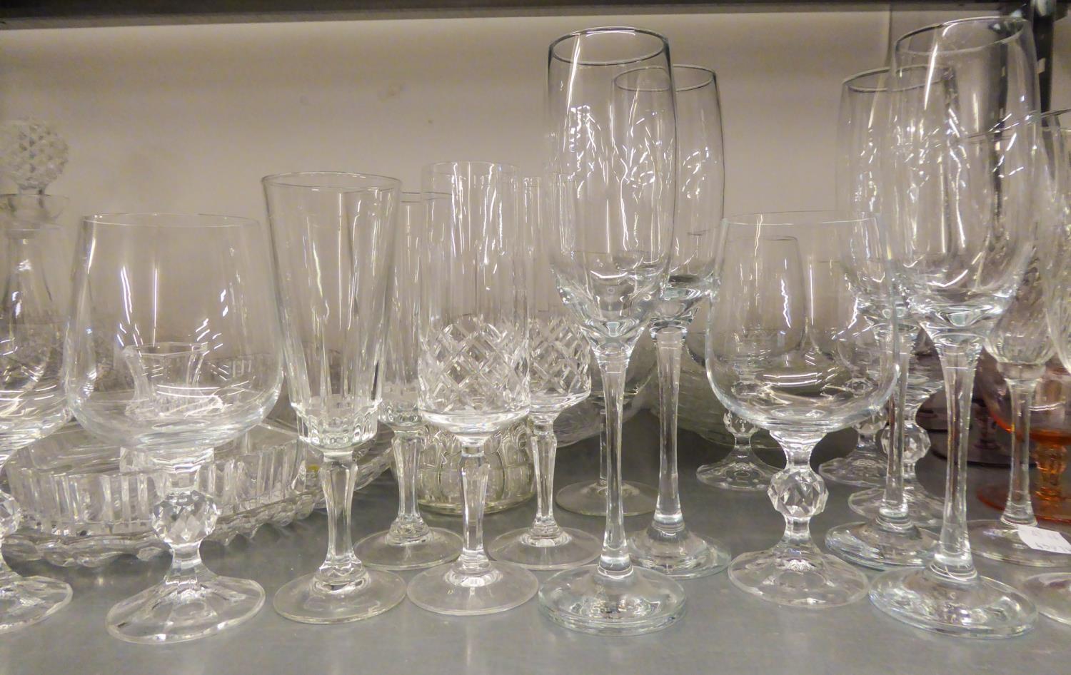 QUANTITY OF CUT AND PLAIN WINE GLASES TO INCLUDE; TWO DECANTERS AND A WINE JUG WITH PLATED HANDLE