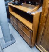 A NATHAN, TEAK SIDE UNIT, ONE OPEN COMPARTMENT OVER A CUPBOARD BASE, ENCLOSED BY TWO FOUR PANEL