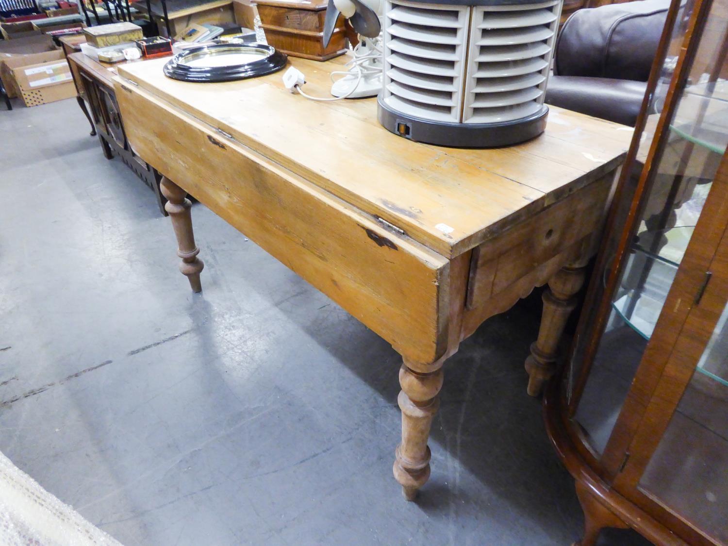 A PINE DROP-LEAF TABLE, WITH TWO DRAWERS, RAISED ON TURNED SUPPORTS (122cm x 106cm x 75cm) AND A BOW