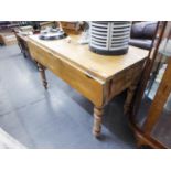 A PINE DROP-LEAF TABLE, WITH TWO DRAWERS, RAISED ON TURNED SUPPORTS (122cm x 106cm x 75cm) AND A BOW