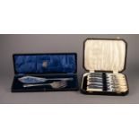 CASED PAIR OF ELECTROPLATED FISH SERVERS, with foliate scroll decorated handles ad blades, the