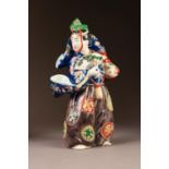 JAPANESE IMARI PORCELAIN FIGURE, modelled in elaborate robes and hat, carrying an open fan, 11? (