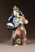 JAPANESE IMARI PORCELAIN FIGURE, modelled in elaborate robes and hat, carrying an open fan, 11? (