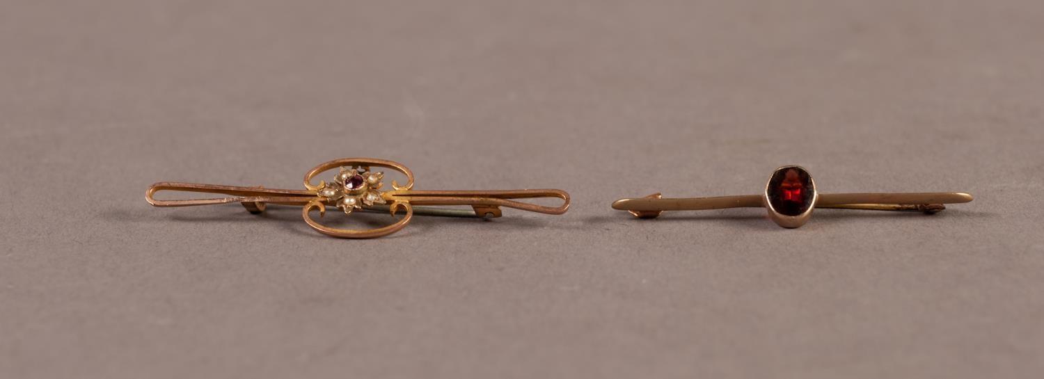 9ct GOLD BAR BROOCH collet set with an oval garnet and a 9ct GOLD OPEN WORK BAR BROOCH with centre