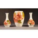 THREE PIECES OF WALTER MOORCROFT POTTERY  VIZ an OVOID VASE and a PAIR OF BOTTLE SHAPED VASES,