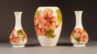 THREE PIECES OF WALTER MOORCROFT POTTERY  VIZ an OVOID VASE and a PAIR OF BOTTLE SHAPED VASES,