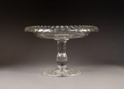 NINETEENTH CENTURY HEAVY CUT GLASS TAZZA, the dished top with fold-over rim, above a solid