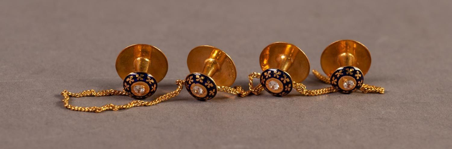 SET OF FOUR DRESS STUDS LINKED BY A FINE CHAIN, each stud set with a white stone within a black