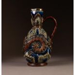 DOULTON LAMBETH MOULDED STONEWARE EWER BY FRANK BUTLER, of footed form with slightly flared neck and