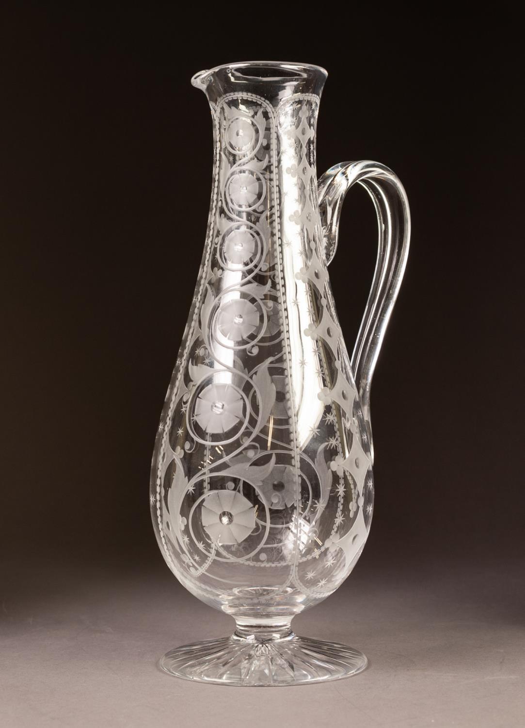 MODERN GLASS PEDESTAL EWER, of slender baluster form with scroll handle, wheel cut with vertical