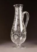 MODERN GLASS PEDESTAL EWER, of slender baluster form with scroll handle, wheel cut with vertical