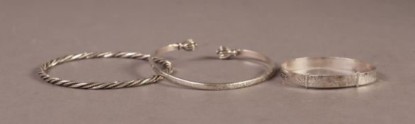 STERLING SILVER BANGLE overlapping to expand and with bright cut engraved decoration, STERLING