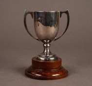 GEORGE V TWO HANDLED SILVER TROPHY CUP, 4? (10.2cm) high, Birmingham 1925, on a turned wood base,