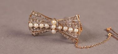 ART DECO GOLD AND WHITE GOLD, DIAMOND AND PEARL BOW BROOCH, set with a cruciform of eleven wired-