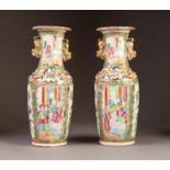 PAIR OF LATE NINETEENTH/ EARLY TWENTIETH CENTURY TWO HANDLED FAMILLE ROSE PORCELAIN VASES, each of