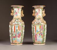 PAIR OF LATE NINETEENTH/ EARLY TWENTIETH CENTURY TWO HANDLED FAMILLE ROSE PORCELAIN VASES, each of