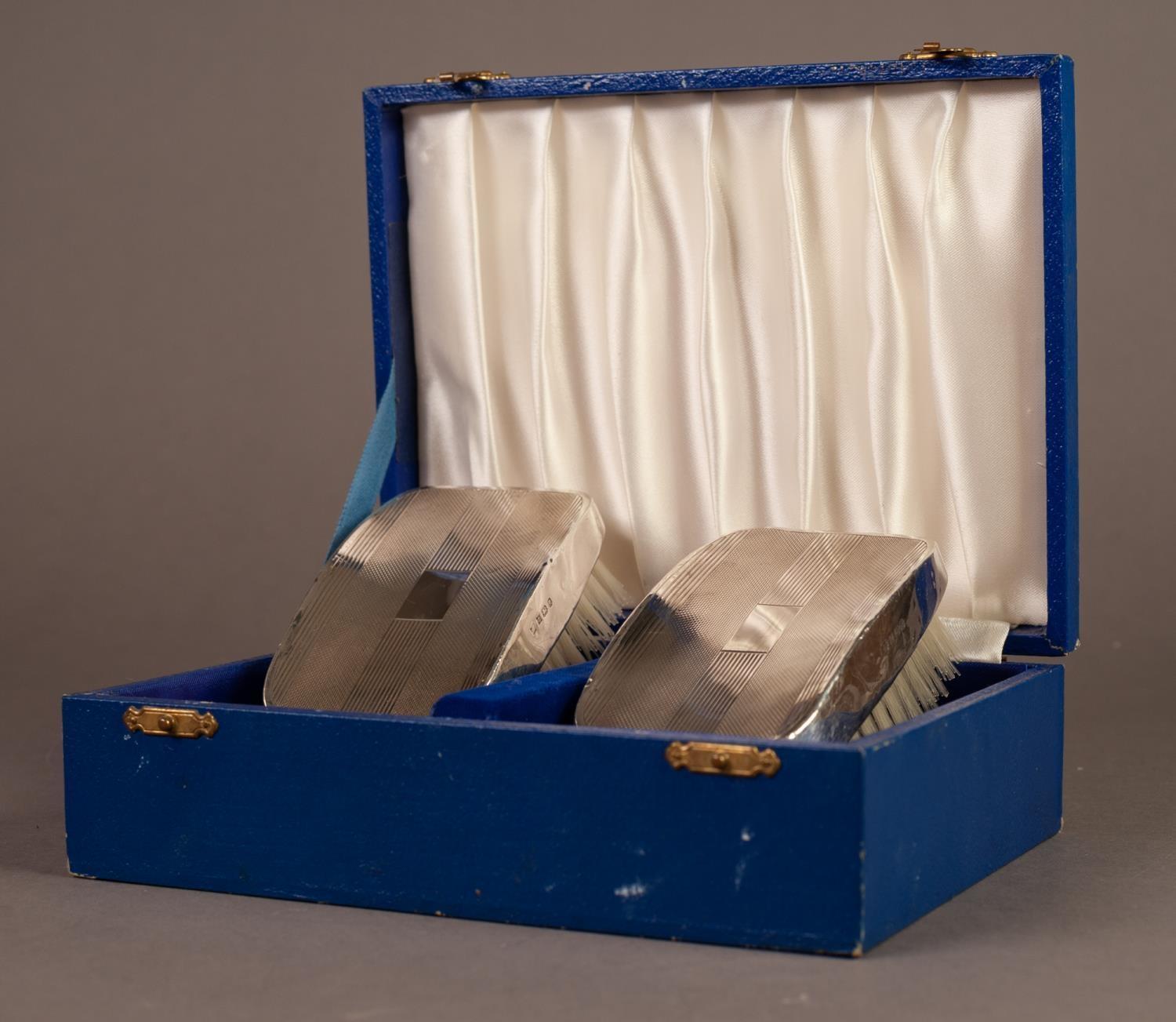 BOXED PAIR OF ENGINE TURNED FILLED SILVER BACKED MILITARY HAIR BRUSHES, Birmingham 1975 - Image 3 of 3