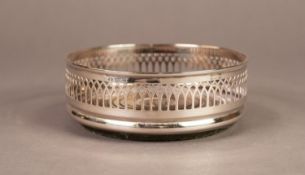 MODERN PIERCED SILVER BOTTLE COASTER, of typical form with turned wood base, 2? (5.1cm) high,