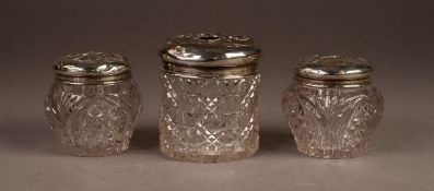 EDWARD VII PAIR OF CUT GLASS TOILET JARS WITH PULL-OFF SILVER COVERS, embossed with angelic faces,