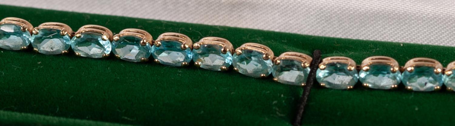 A 10k YELLOW GOLD BRACELET, claw set with twenty nine pale blue topaz stones, 7.0oz gross - Image 3 of 3