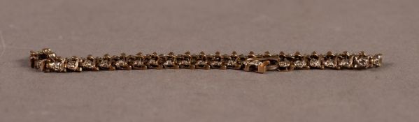 9ct GOLD AND DIAMOND BRACELET with forty four 'D' shaped links, each set with a tiny diamond, 7 1/2"