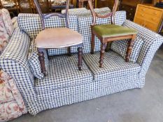 PAIR OF TWO SEATER SETTEES COVERED IN PATTERNED MAROON FABRIC WITH CHECK FABRIC LOOSE COVERS AND THE