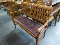 POLISHED WOOD HALL SEAT, WITH TRELLS PATTERN BACK, OPEN ARMS AND PAD SEAT, ON SEMI CABRIOLE