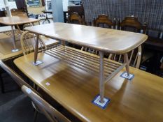 AN ERCOL LIGHT ELM OBLONG COFFEE TABLE WITH RAILED UNDERSHELF